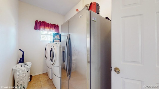 laundry area featuring washer and dryer and light tile patterned floors