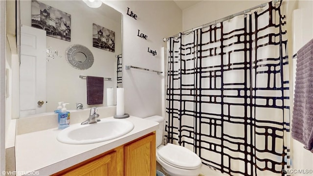 bathroom featuring toilet and vanity