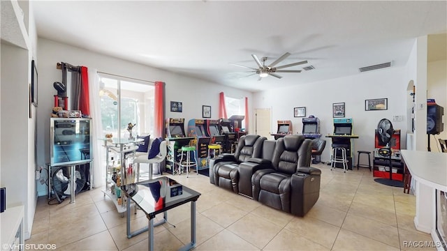 tiled living room with ceiling fan