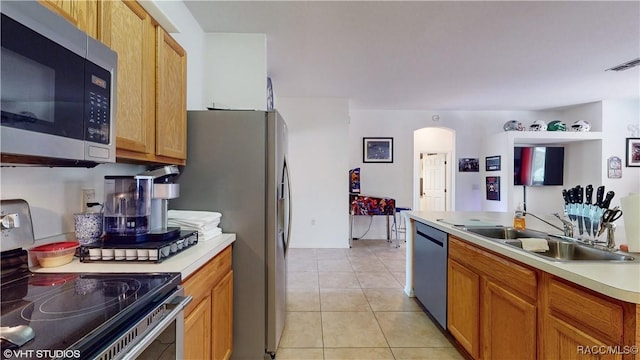 kitchen with sink, light tile patterned flooring, and appliances with stainless steel finishes