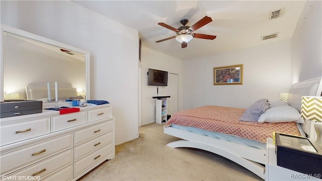 bedroom with ceiling fan and light carpet