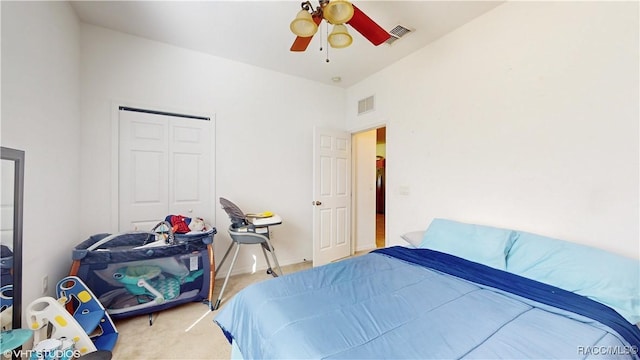 bedroom with ceiling fan, a closet, and carpet floors