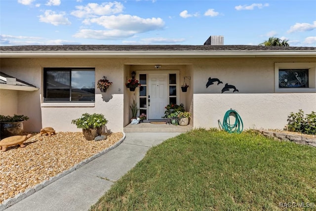 3945 N Timucua Pt, Crystal River, FL 34428 - view of exterior entry with a yard and stucco siding