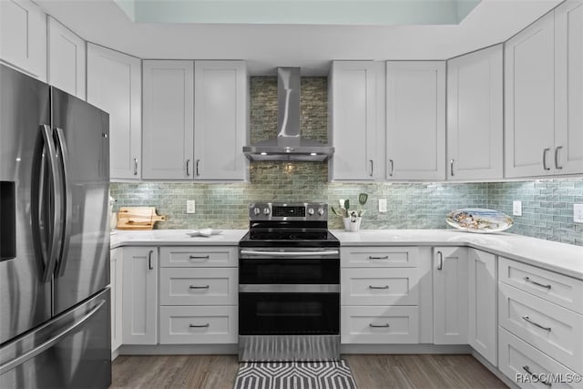 3945 N Timucua Pt, Crystal River, FL 34428 - kitchen featuring wall chimney range hood, appliances with stainless steel finishes, light countertops, and light wood-style floors