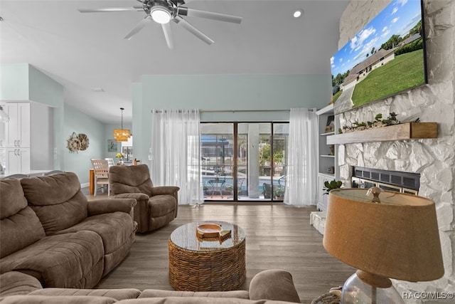 3945 N Timucua Pt, Crystal River, FL 34428 - living area featuring a stone fireplace, high vaulted ceiling, ceiling fan, and wood finished floors