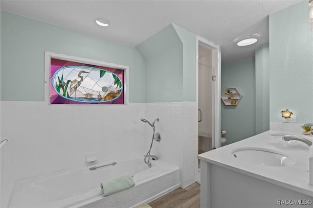 3945 N Timucua Pt, Crystal River, FL 34428 - full bathroom featuring toilet, a bath, a sink, double vanity, and wood finished floors