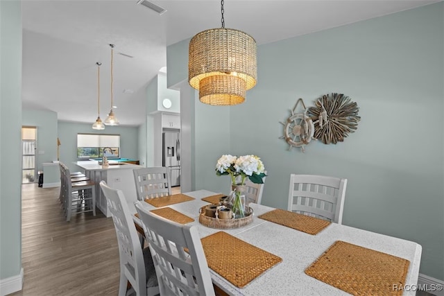 3945 N Timucua Pt, Crystal River, FL 34428 - dining area featuring an inviting chandelier, visible vents, wood finished floors, and baseboards