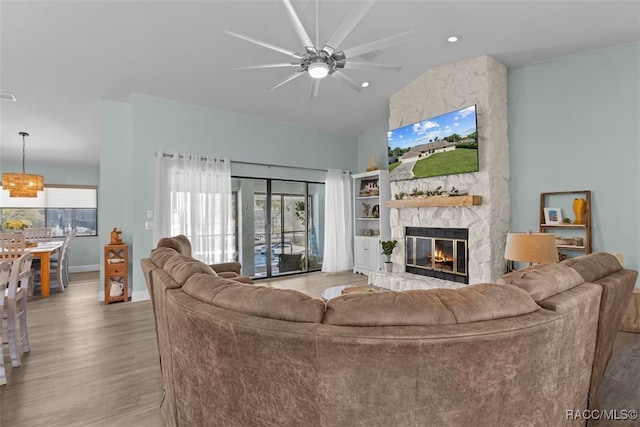 3945 N Timucua Pt, Crystal River, FL 34428 - living area featuring a healthy amount of sunlight, a fireplace, ceiling fan, and wood finished floors