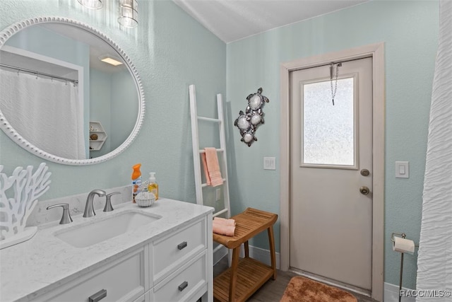 3945 N Timucua Pt, Crystal River, FL 34428 - full bathroom with baseboards, vanity, and a textured wall