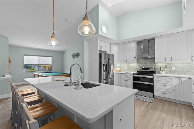 3945 N Timucua Pt, Crystal River, FL 34428 - kitchen featuring a breakfast bar, a sink, wall chimney range hood, tasteful backsplash, and appliances with stainless steel finishes
