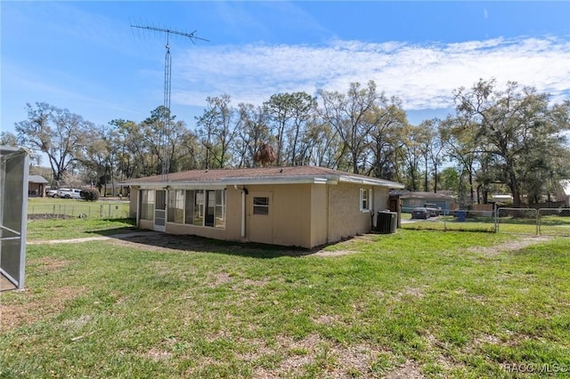 back of house with a yard, cooling unit, and fence