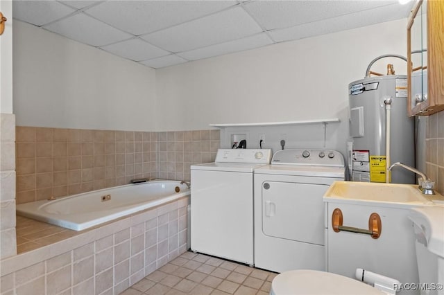 laundry area with washing machine and dryer, water heater, and light tile patterned floors