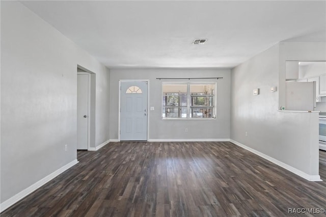 foyer entrance featuring visible vents, baseboards, and wood finished floors