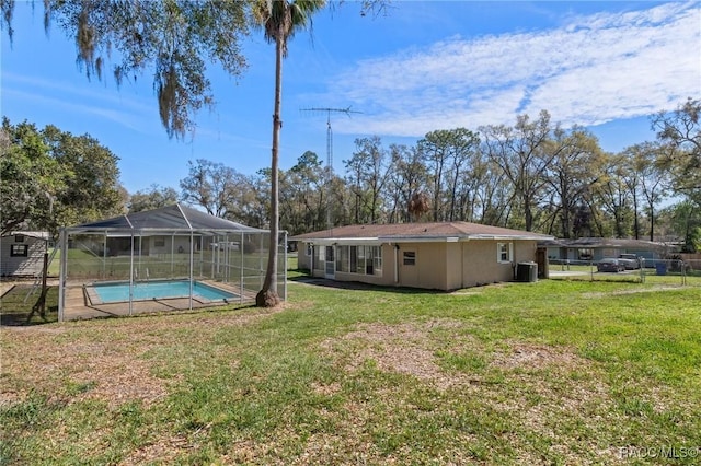 view of yard with cooling unit, glass enclosure, and an outdoor pool