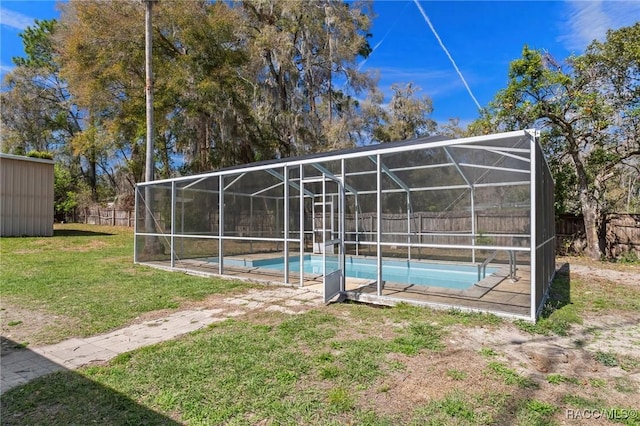 view of pool featuring a fenced in pool, glass enclosure, a lawn, and fence