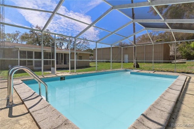 outdoor pool with glass enclosure and a lawn