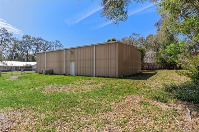 view of pole building featuring a yard and fence