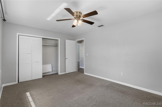 unfurnished bedroom featuring carpet floors, a closet, visible vents, and baseboards