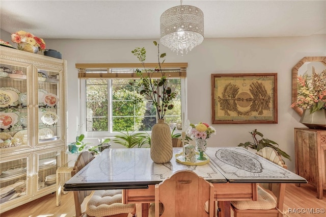 dining room with a chandelier and light wood-type flooring