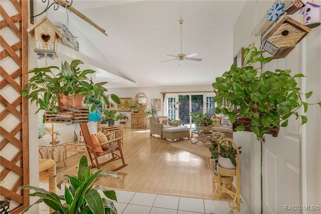 sunroom with lofted ceiling and a ceiling fan