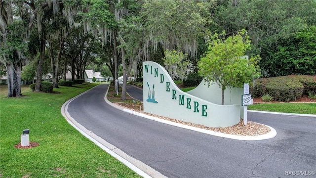 community / neighborhood sign with a lawn