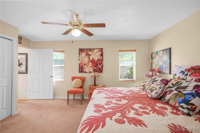 carpeted bedroom featuring baseboards, a textured ceiling, and ceiling fan