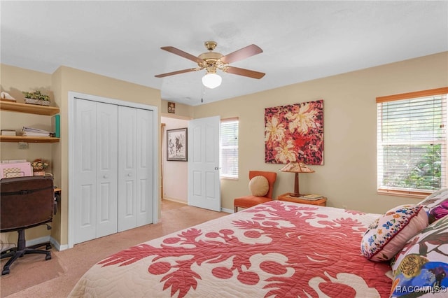 bedroom featuring a closet, light carpet, baseboards, and a ceiling fan