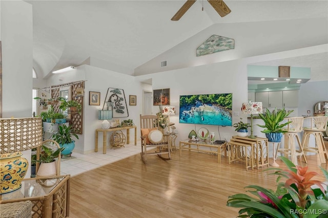 living room featuring wood finished floors, high vaulted ceiling, and ceiling fan