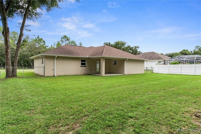 back of house with a yard