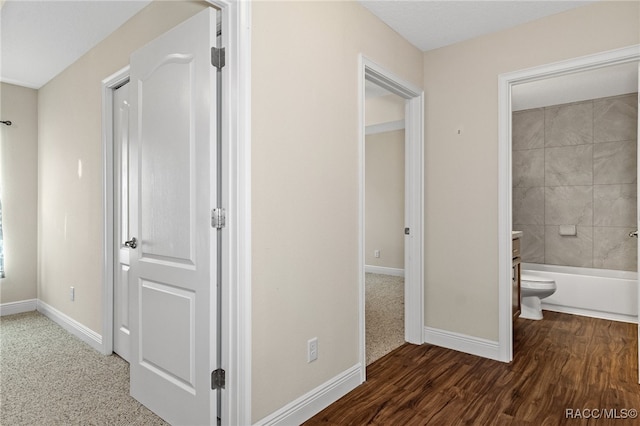 hall with dark hardwood / wood-style flooring