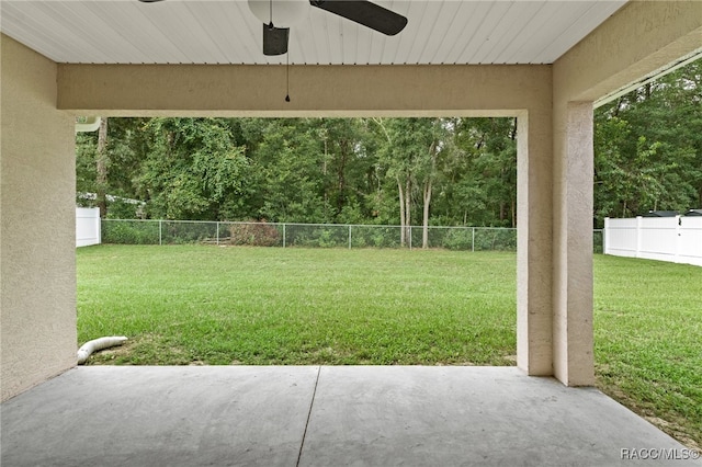 view of yard with a patio area and ceiling fan