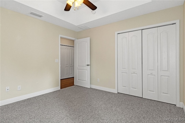 unfurnished bedroom with carpet floors, a closet, and ceiling fan