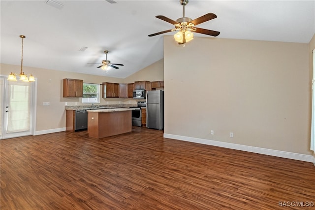 kitchen featuring appliances with stainless steel finishes, a center island, dark hardwood / wood-style floors, and lofted ceiling