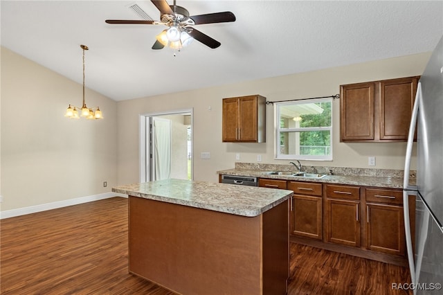 kitchen featuring sink, hanging light fixtures, dark hardwood / wood-style flooring, vaulted ceiling, and a kitchen island