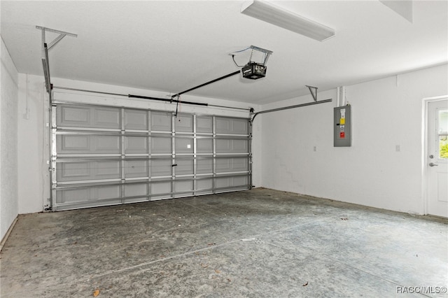 garage with electric panel and a garage door opener