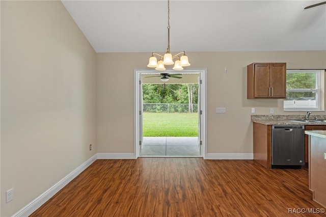 kitchen featuring sink, hanging light fixtures, vaulted ceiling, stainless steel dishwasher, and dark hardwood / wood-style floors