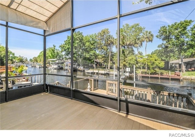 unfurnished sunroom featuring a water view and wooden ceiling