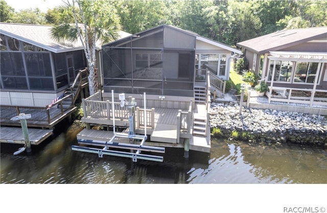 dock area featuring a deck with water view and a lanai