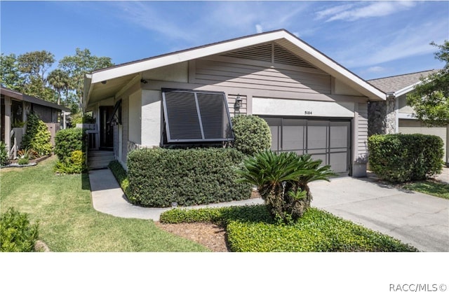 view of front of house with a front lawn and a garage