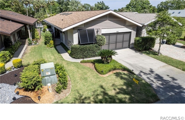 view of front of home with a front yard and a garage