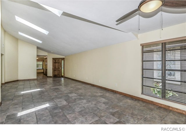 unfurnished room with ceiling fan and vaulted ceiling