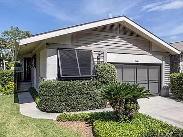 view of front facade with a front yard and a garage