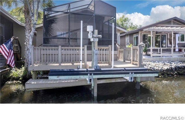 rear view of house with a deck with water view