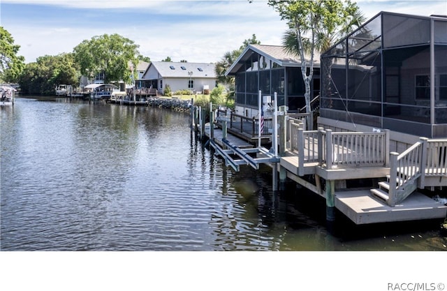 dock area featuring glass enclosure and a water view