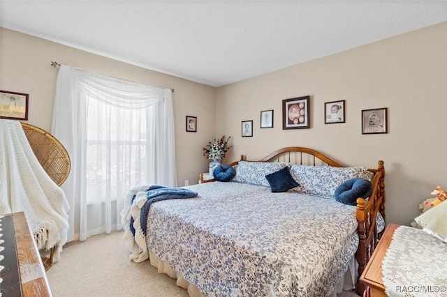 bedroom featuring light colored carpet