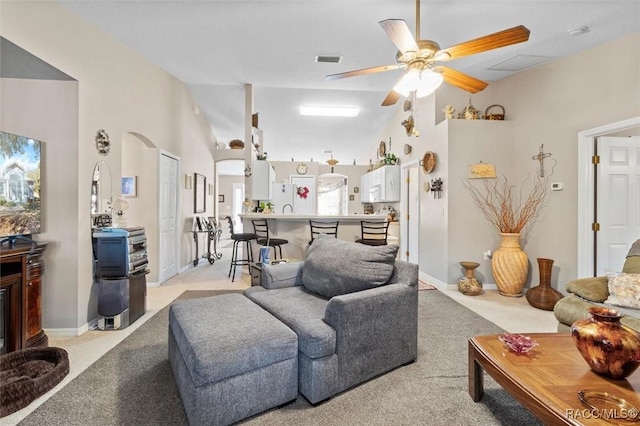 living room with ceiling fan, light colored carpet, and high vaulted ceiling