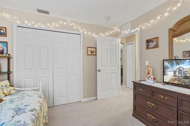 bedroom featuring light carpet, a closet, and visible vents