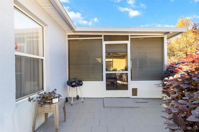 doorway to property with a patio area