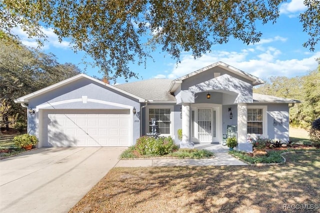 1923 W Mcneal Dr, Citrus Springs, FL 34434 - ranch-style house featuring an attached garage, stucco siding, and concrete driveway