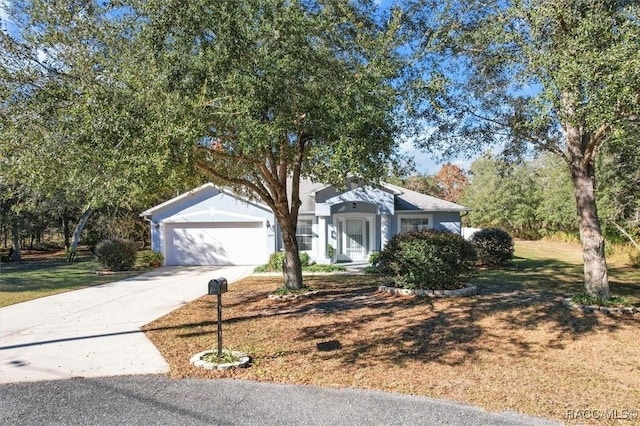 1923 W Mcneal Dr, Citrus Springs, FL 34434 - ranch-style home featuring concrete driveway, a front lawn, a garage, and stucco siding